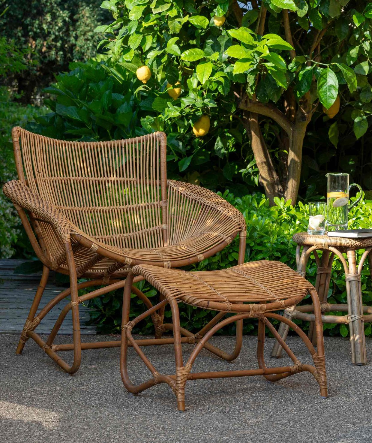 Natural Rattan Lounge Armchair and Footstool under Lemon Tree — Brucs 2026 Catalog Page 29